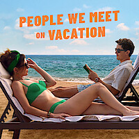 Two people on sun loungers on the beach