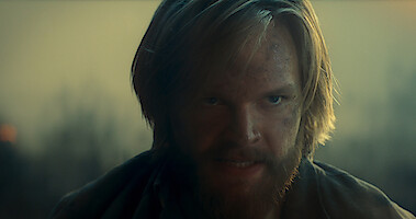 Bearded protagonist in Ragnarok looking determined and angry.