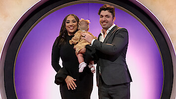 Bliss Poureetezadi Goytowski and Zack Goytowski holding their baby.