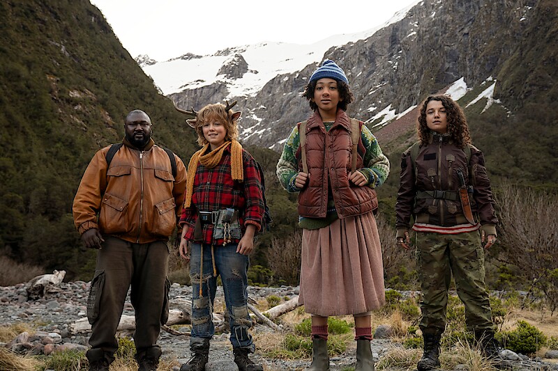 Nonso Anozie as Jepperd, Christian Convery as Gus, Naledi Murray as Wendy, and Stefania LaVie Owen as Becky stand together in a mountain range in season 3 of "Sweet Tooth'