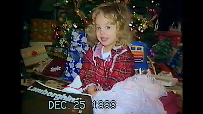 JonBenét Ramsey seen opening presents on Christmas from home video footage.