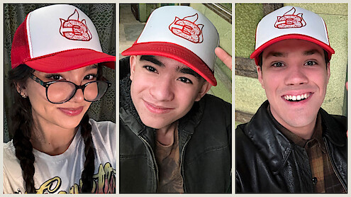 Kiawentiio, Gordon Cormier, and Ian Ousley wear a hat with a 3 and the 'Avatar: The Last Airbender' Fire Nation logo on it. 