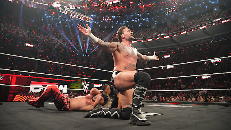 Seth Rollins and CM Punk in the ring.