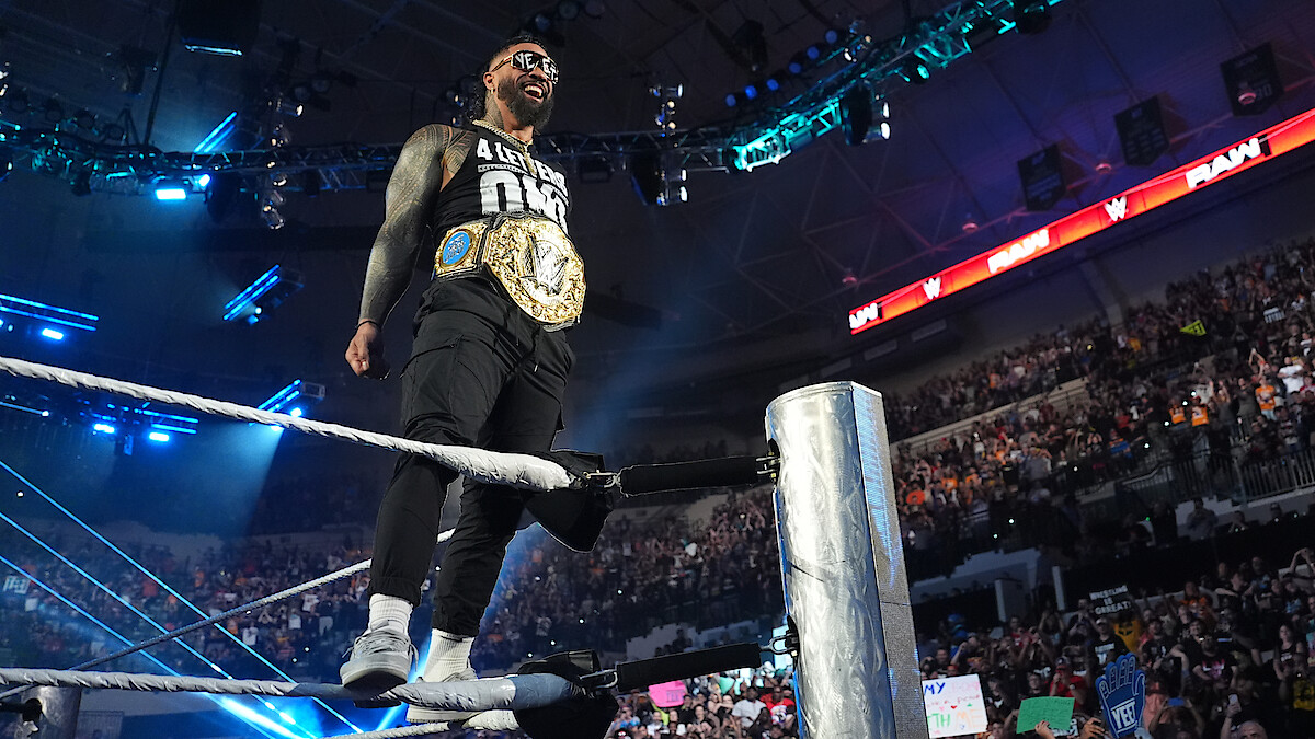 Jey Uso standing on a rope with his belt on facing the crowd.