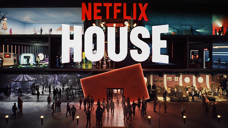 Crowds walk outside a modern, vibrant building labeled "Netflix House," with colorful rooms inside inspired by different Netflix shows.