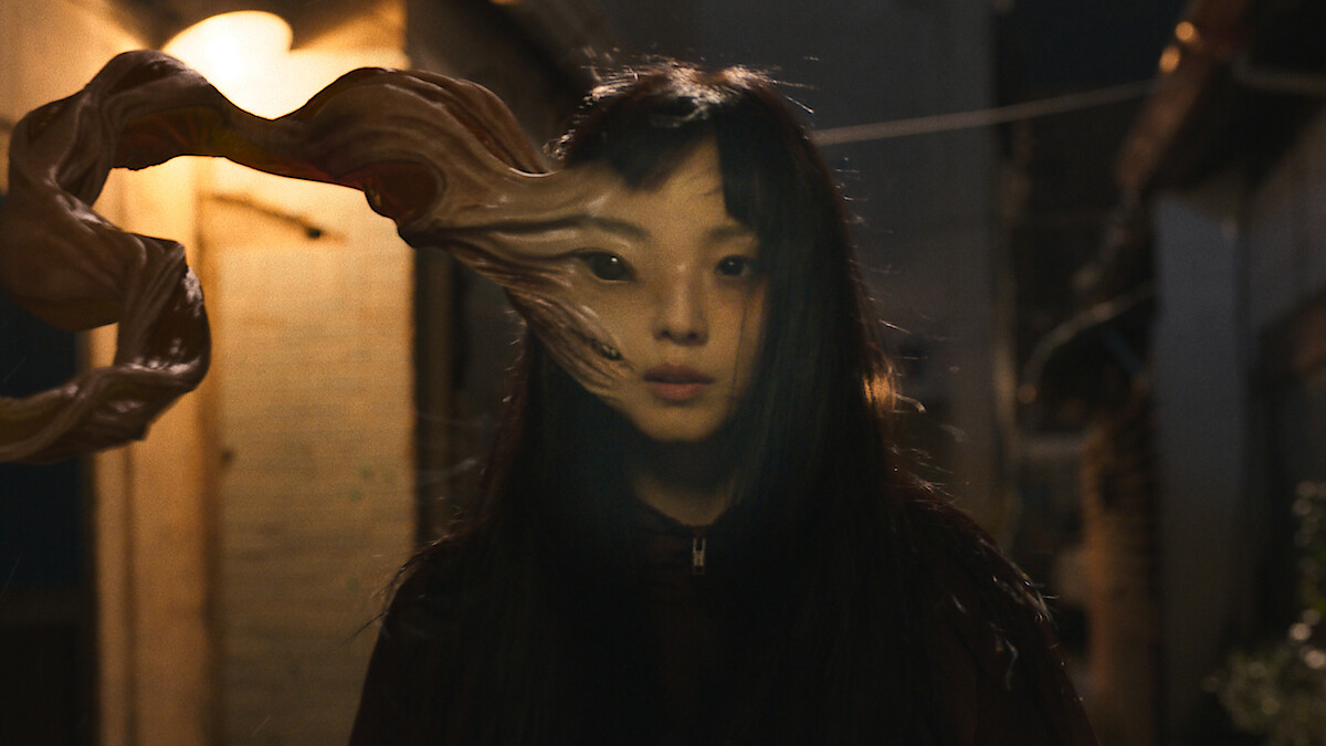 An tentacle-like appendage grows from a woman's head in season 1 of 'Parasyte: The Grey'