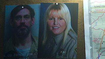 A photo of Casey White and Vicky White pinned to a board.