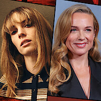 Two women side by side: one with straight hair and bangs in a striped shirt against a tan background, the other with wavy blonde hair in a dark outfit, smiling in front of a blue-gray backdrop.