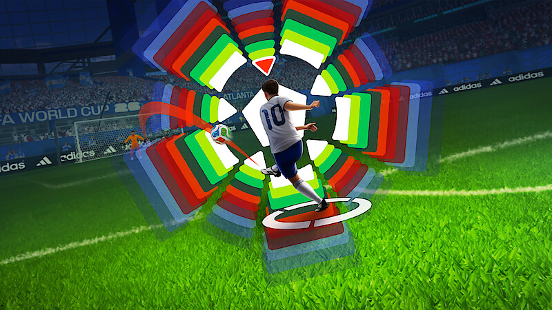 Soccer player in white jersey taking a shot on goal in a stadium, with colorful digital graphics showing trajectory and power settings, crowd and banners visible in the background.