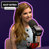 Anna Kendrick, smiling in front of a microphone labeled "SKIP INTRO." She wears a sleeveless, light blue top. The background is deep purple with a purple outline around her.