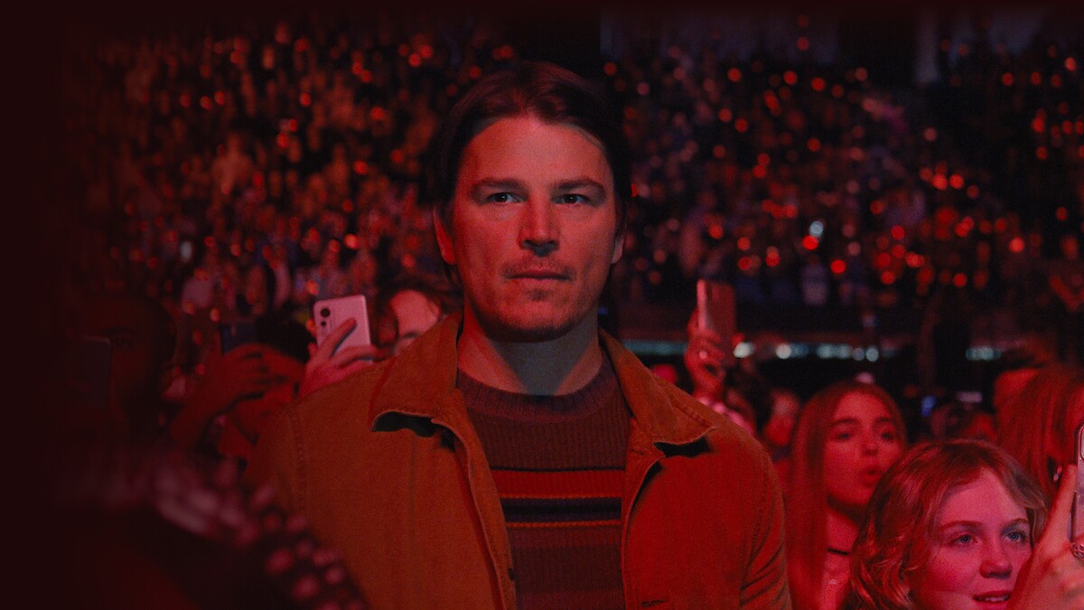 Josh Hartnett as Cooper standing in a crowd during a concert in the film Trap.