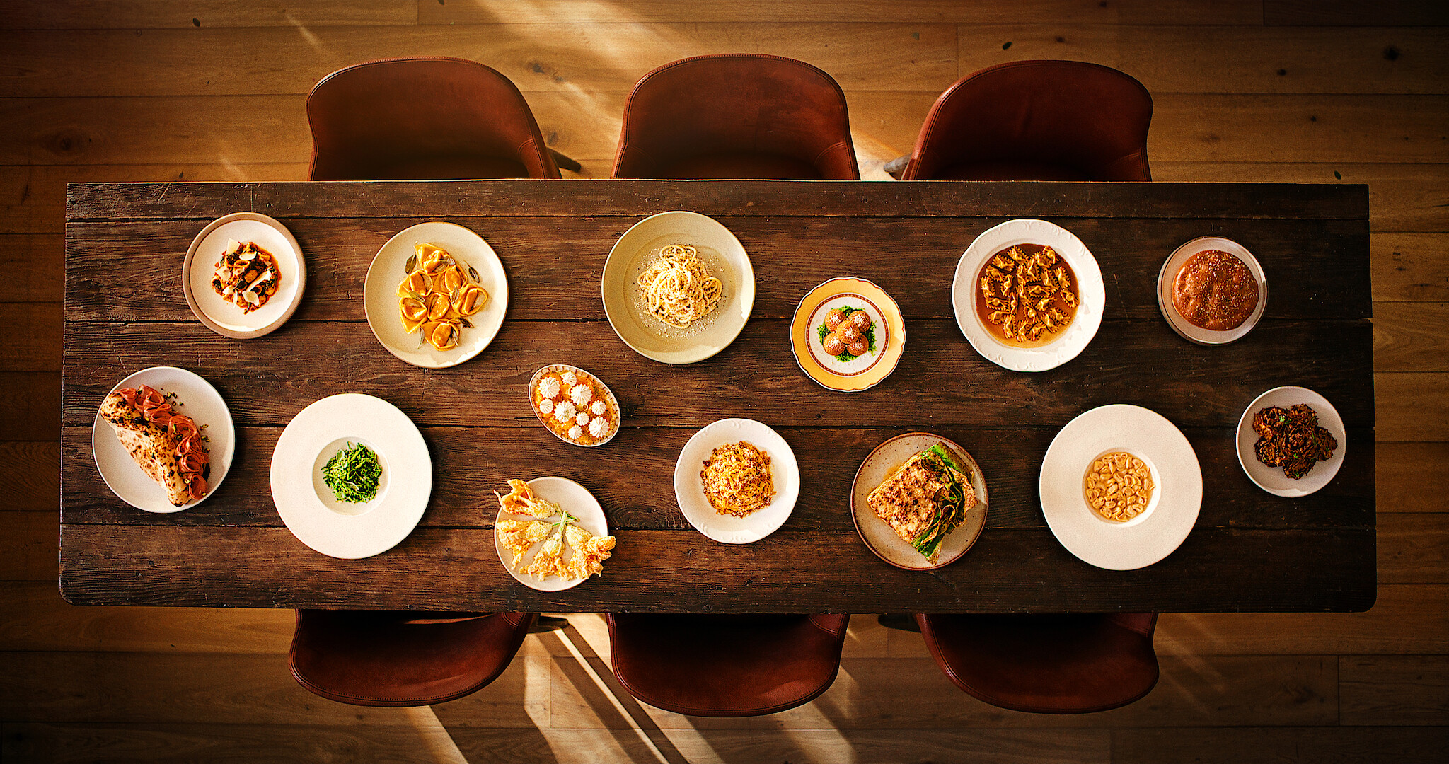 A view looking down on a table that is holding several bowls of ramen noodles. 