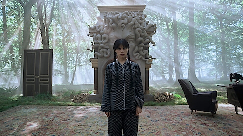 Jenna Ortega as Wednesday Addams holding an eyeball with tongs in 'Wednesday' Season 2. 