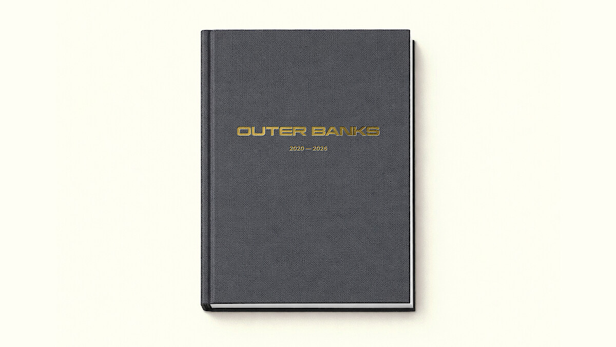 A black hardcover book with gold "Outer Banks 2020–2025" text on the cover, photographed on a plain off-white background.