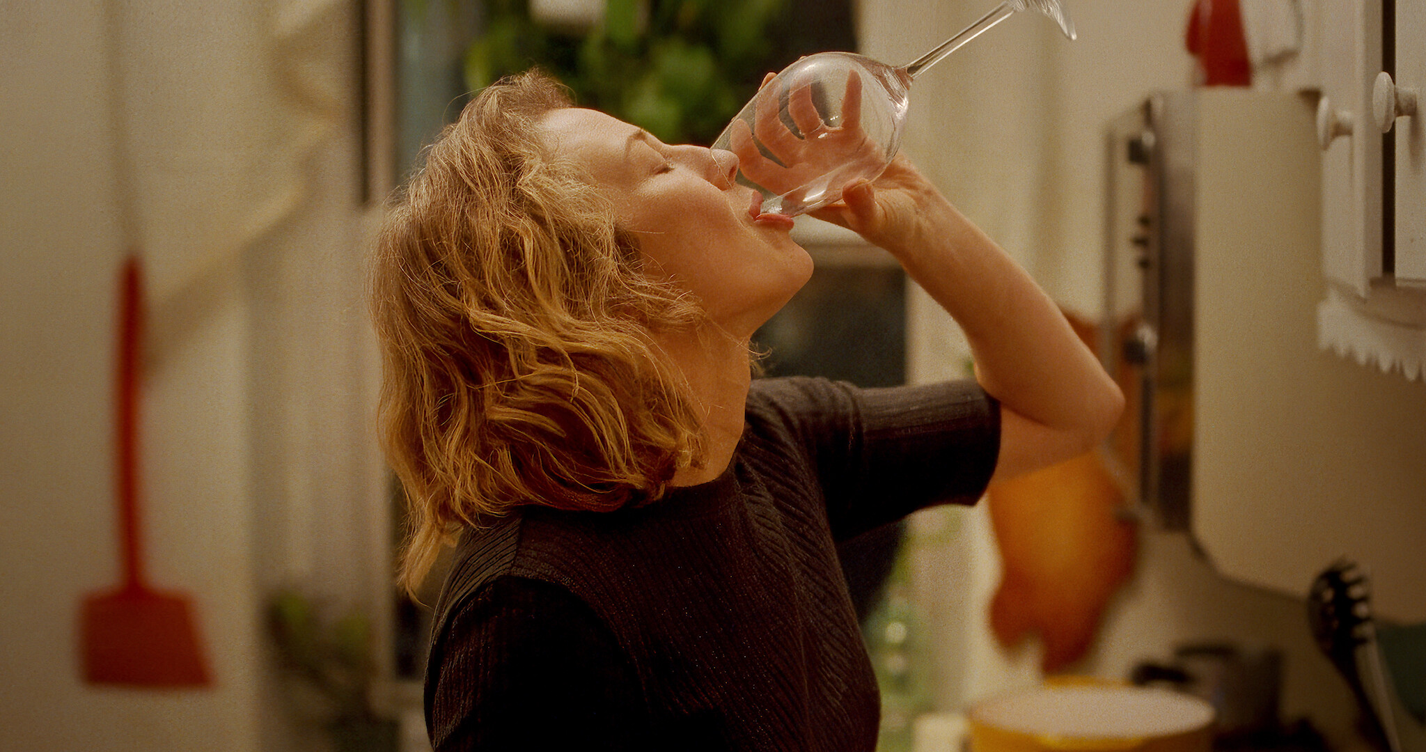 Carrie Coon drinking a glass of wine