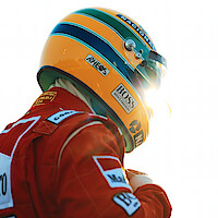 Ayrton Senna (Gabriel Leone) wears a red Marlboro jacket and a green-and-yellow helmet as he gears up to race.