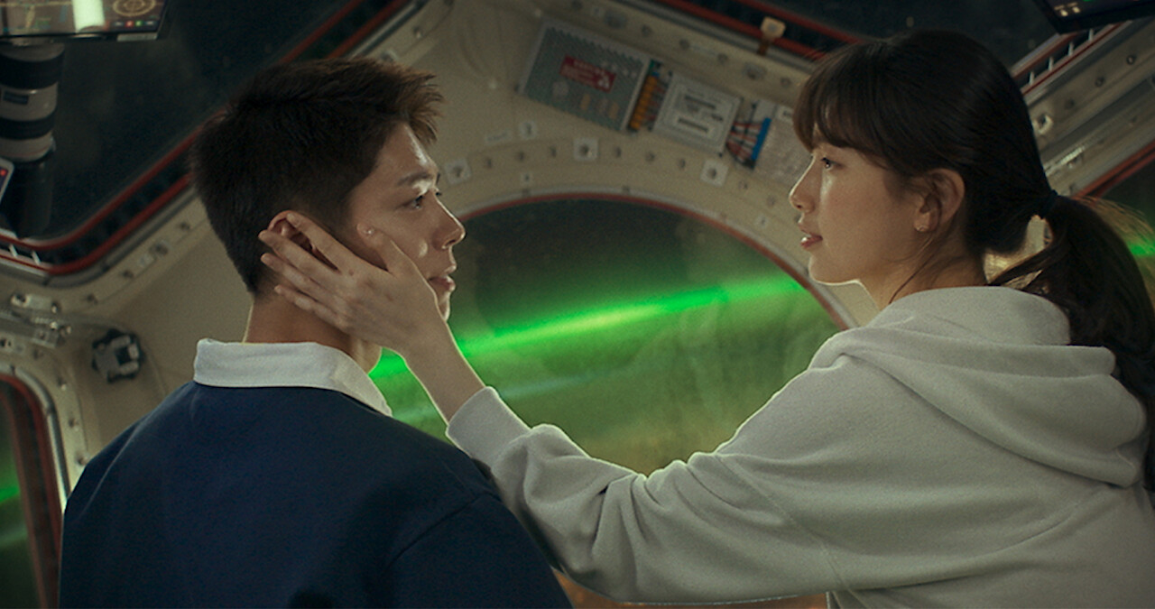 Suzy rests her hand on Park Bo Gum's cheek in an image from the film 'Wonderland.'