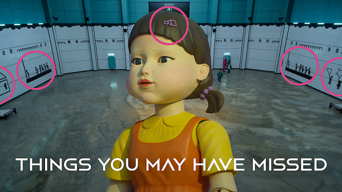 Giant doll figure in yellow dress in a large warehouse-like space with pink circles and text "THINGS YOU MAY HAVE MISSED" at the bottom.
