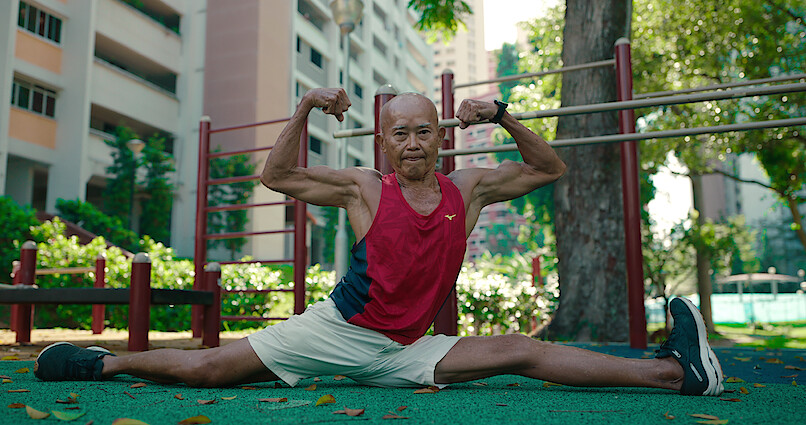 100-year-old man flexes and stretches in "Live to 100: Secrets of the Blue Zones"