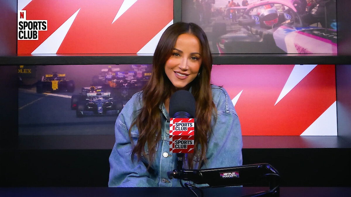 Kay Adams sitting behind a microphone.