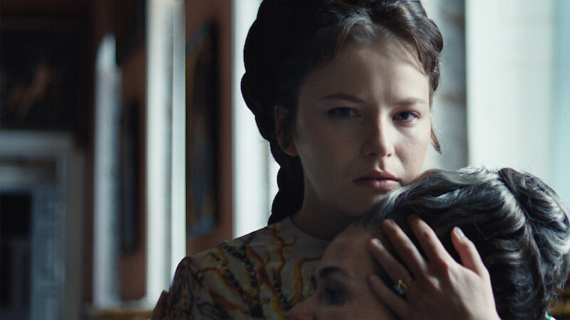 Devrim Lingnau as Elisabeth von Wittelsbach holds a woman's head to her chest in Season 2 of 'The Empress'
