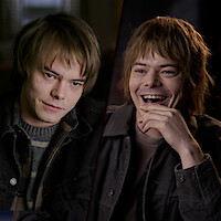 Charlie Heaton with shaggy hair at two ages: younger and serious on the left in casual layers, older and more relaxed on the right under softer studio lighting.