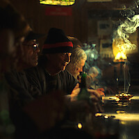 Cast of The Singers pictured seated belly up to the bar.