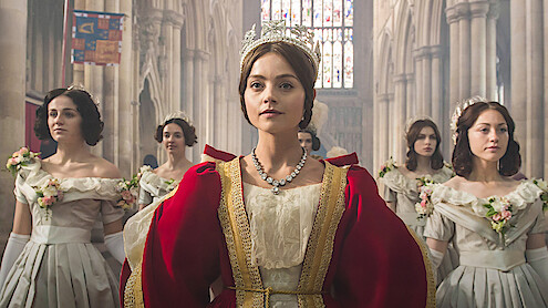  Jenna Coleman as Queen Victoria surrounded by her ladies-in-waiting in 'Victoria.'