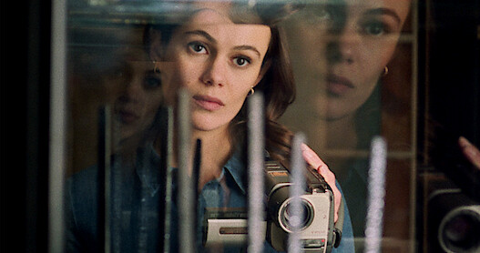 A close up of Melody recording something on her video recorder. 