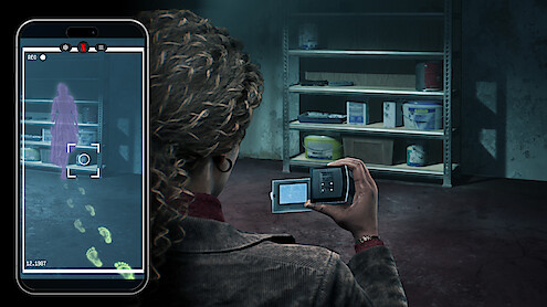 A person in a dark storage room uses a camera and phone to capture evidence, revealing ghostly footprints and a purple apparition on their screen near shelves with paint cans and cleaning supplies.