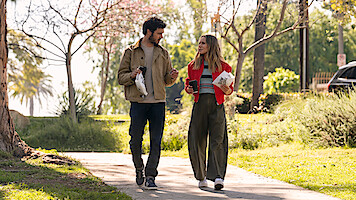 Adam Brody as Noah and Kristen Bell as Joanne walk in a park together in Season 1 of 'Nobody Wants This'