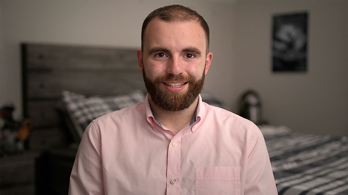 Connor sits in his bedroom.
