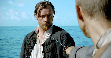Toby Stephens as Captain Flint has a rapier pointed at him in 'Black Sails.' 