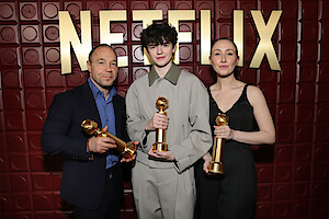 Stephen Graham, Owen Cooper, and Erin Doherty hold their Golden Globe trophies. 
