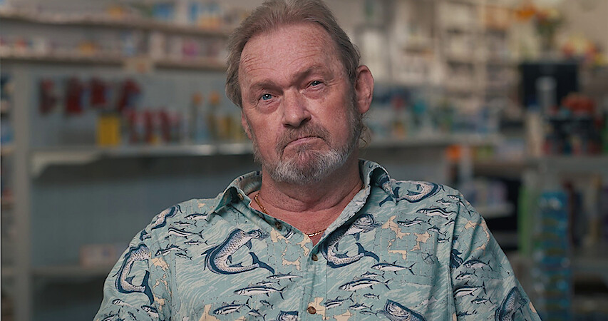 a bearded man in a button down shirt with marlins on it