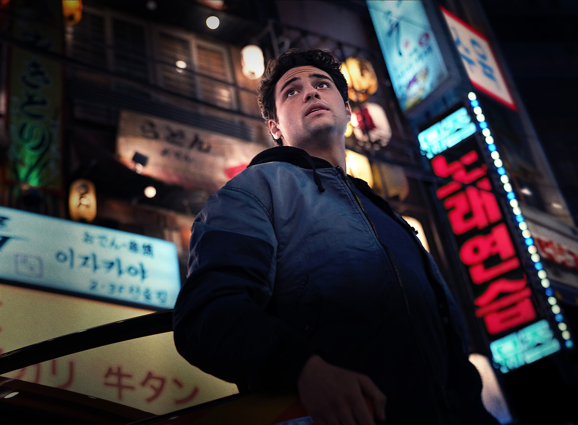 The Recruit season 2 key art - Noah Centeneo looks worried while on the street 