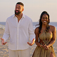 Ollie and AD standing together on the beach.