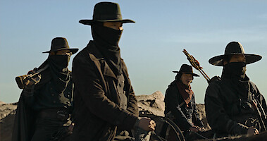 A group of people ride horses wearing all black in Season 1 of 'Song of the Bandits.'