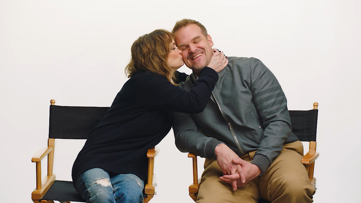 Winona Ryder kisses David Harbour's cheek.
