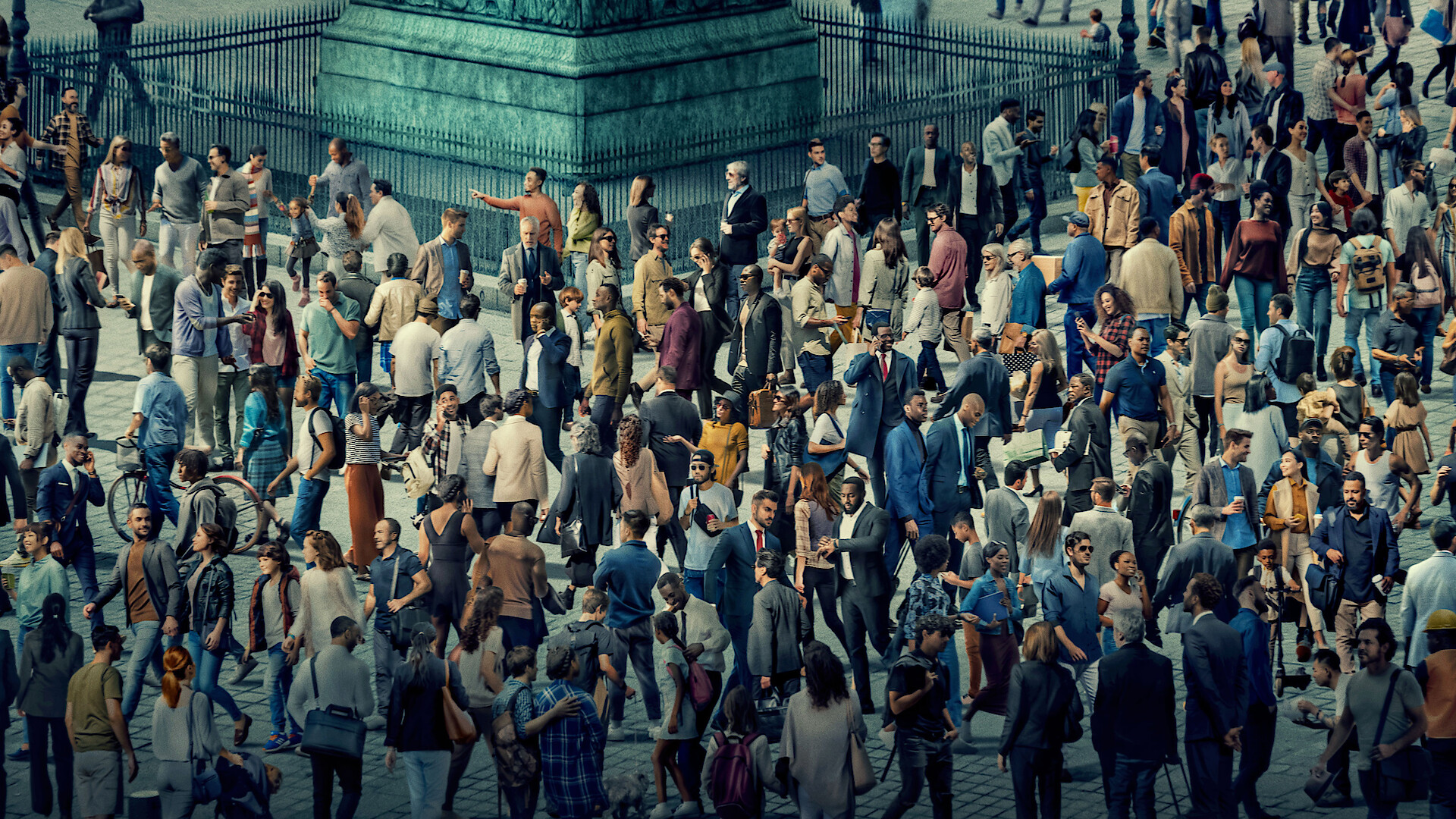 Large crowd of people gathered outdoors in a city square, walking and standing near a monument base on a sunny day, wearing casual and business clothes, creating a busy urban atmosphere.