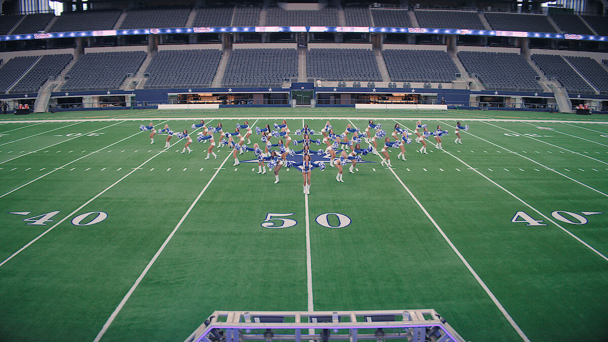 The Dallas Cowboys Cheerleaders on the field.