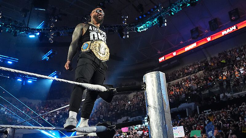 Jey Uso standing on a rope with his belt on facing the crowd.