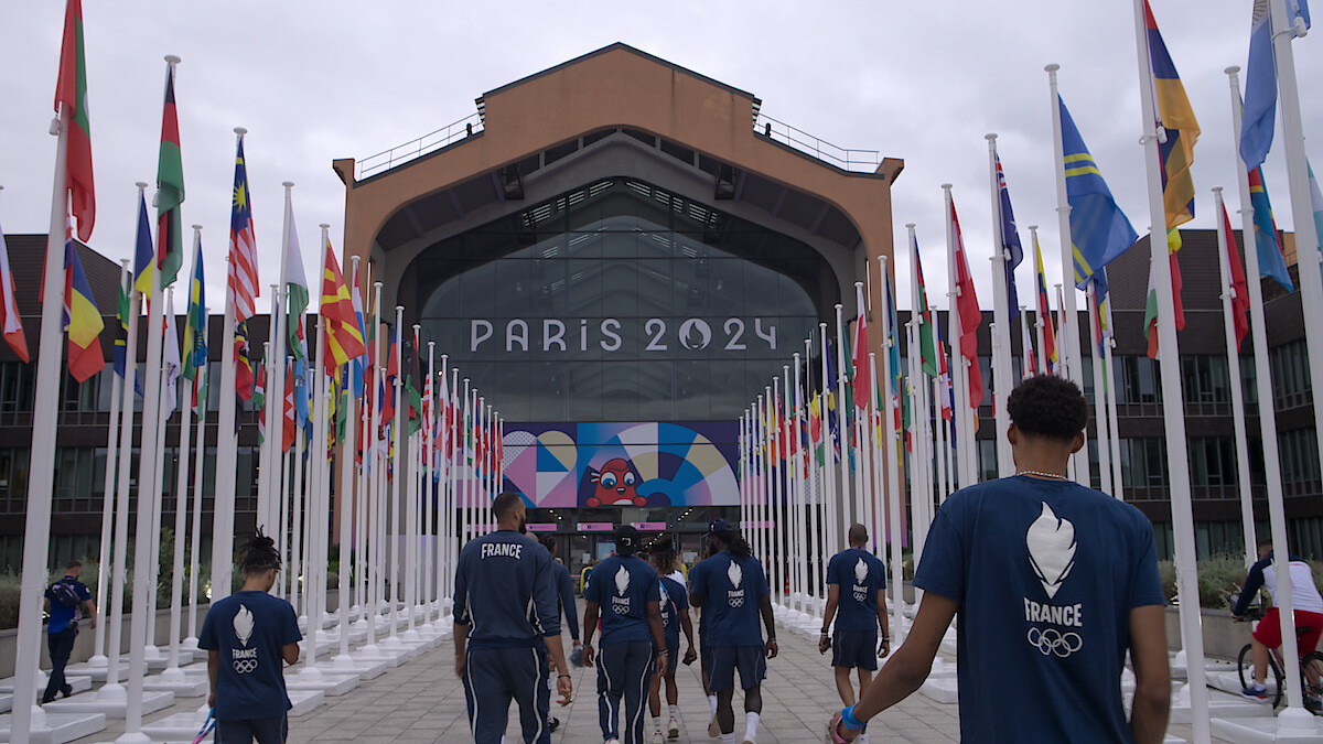 France Basketball Men's Olympic Team entering an arena.