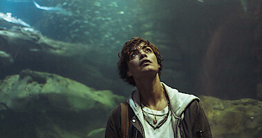 In the French thriller 'Under Paris,' actor Bérénice Bejo stands in front of a large aquarium while looking up.