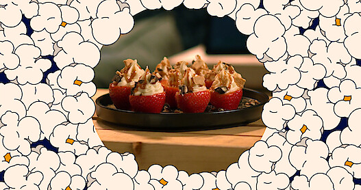 An image of popcorn with cheesecake stuffed strawberries in the middle 