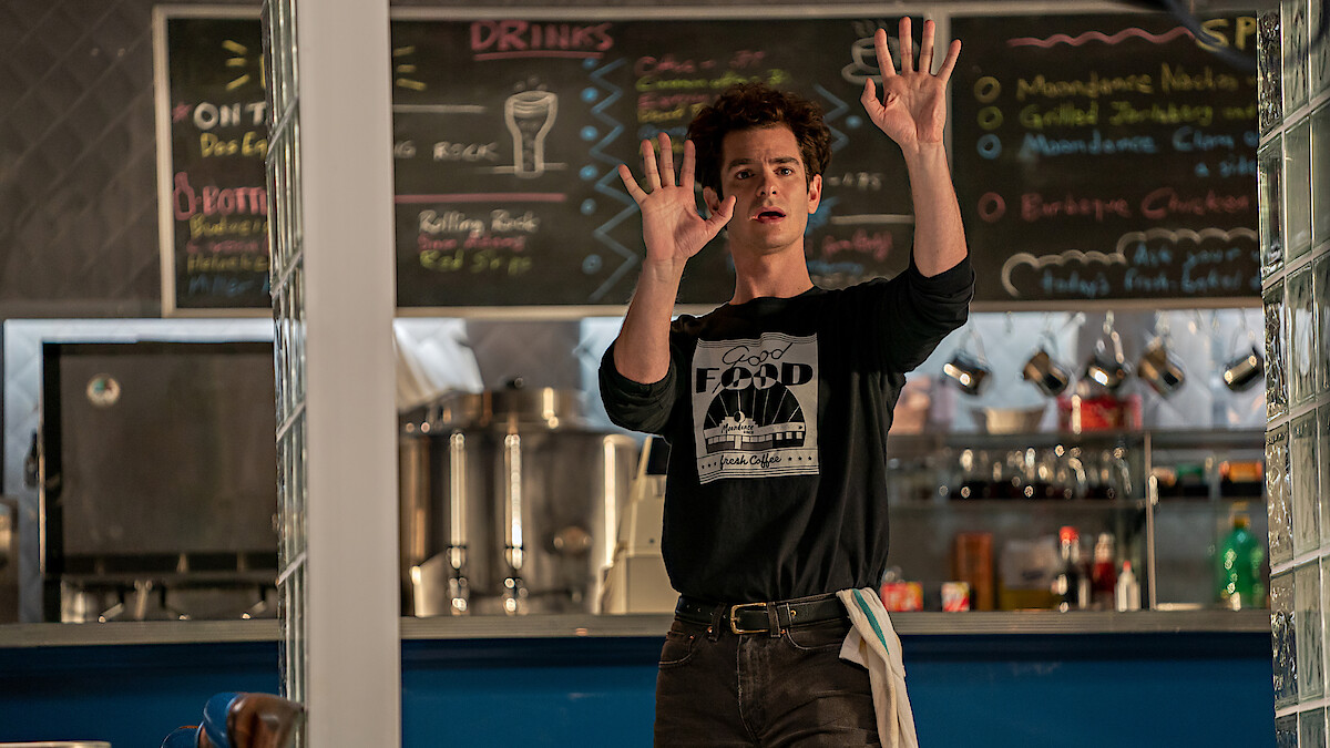 Andrew Garfield in a cafe scene in tick, tick... Boom!