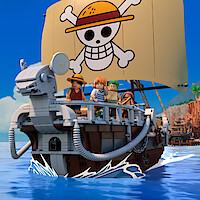 LEGO pirate ship with four minifigures on deck, ocean setting, village and island background, large sail with cartoon skull and straw hat design, bright blue sky.