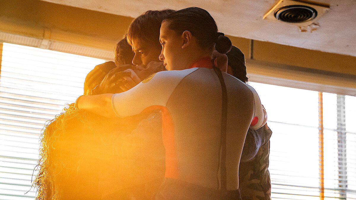 Millie Bobby Brown as Eleven, Charlie Heaton as Jonathan, Noah Schnapp as Will hug in 'Stranger Things 5'