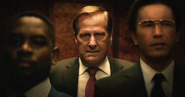 Jeff Daniels as Charlie Crocker stands in an elevator with an angry expression in 'A Man in Full'