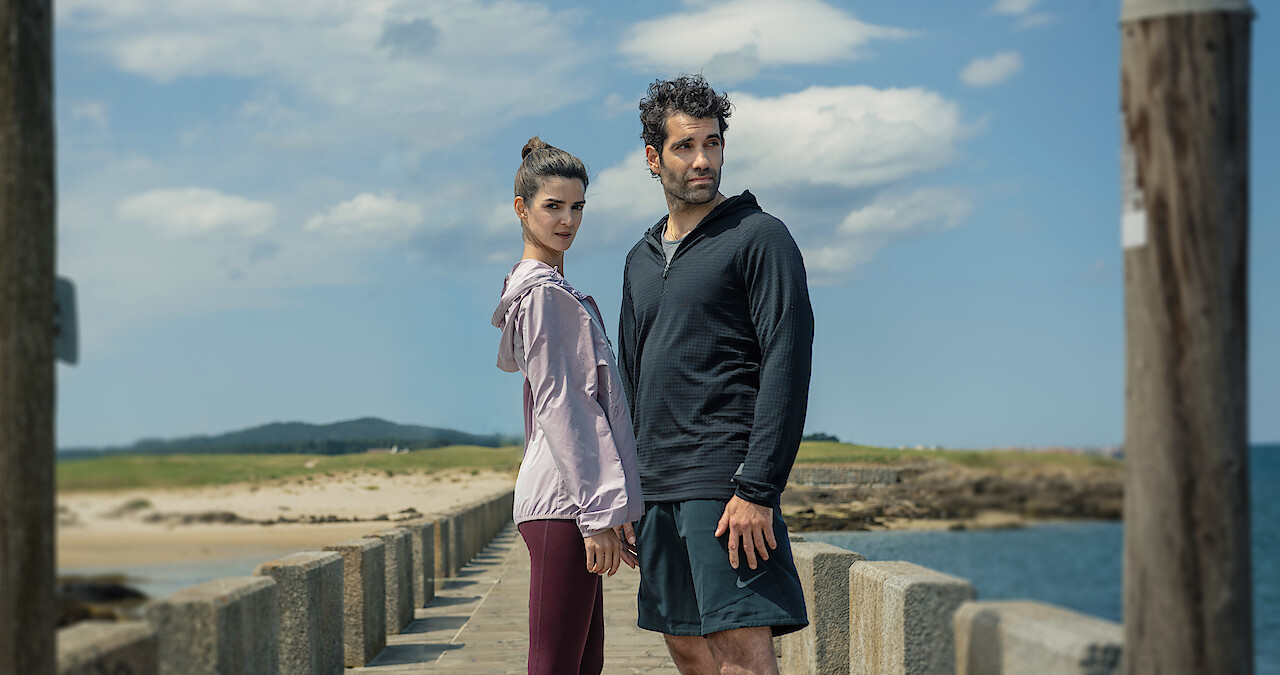 Clara Lago as Ana and Tamar Novas as Daniel stand together on a dock in 'Gangs of Galicia'